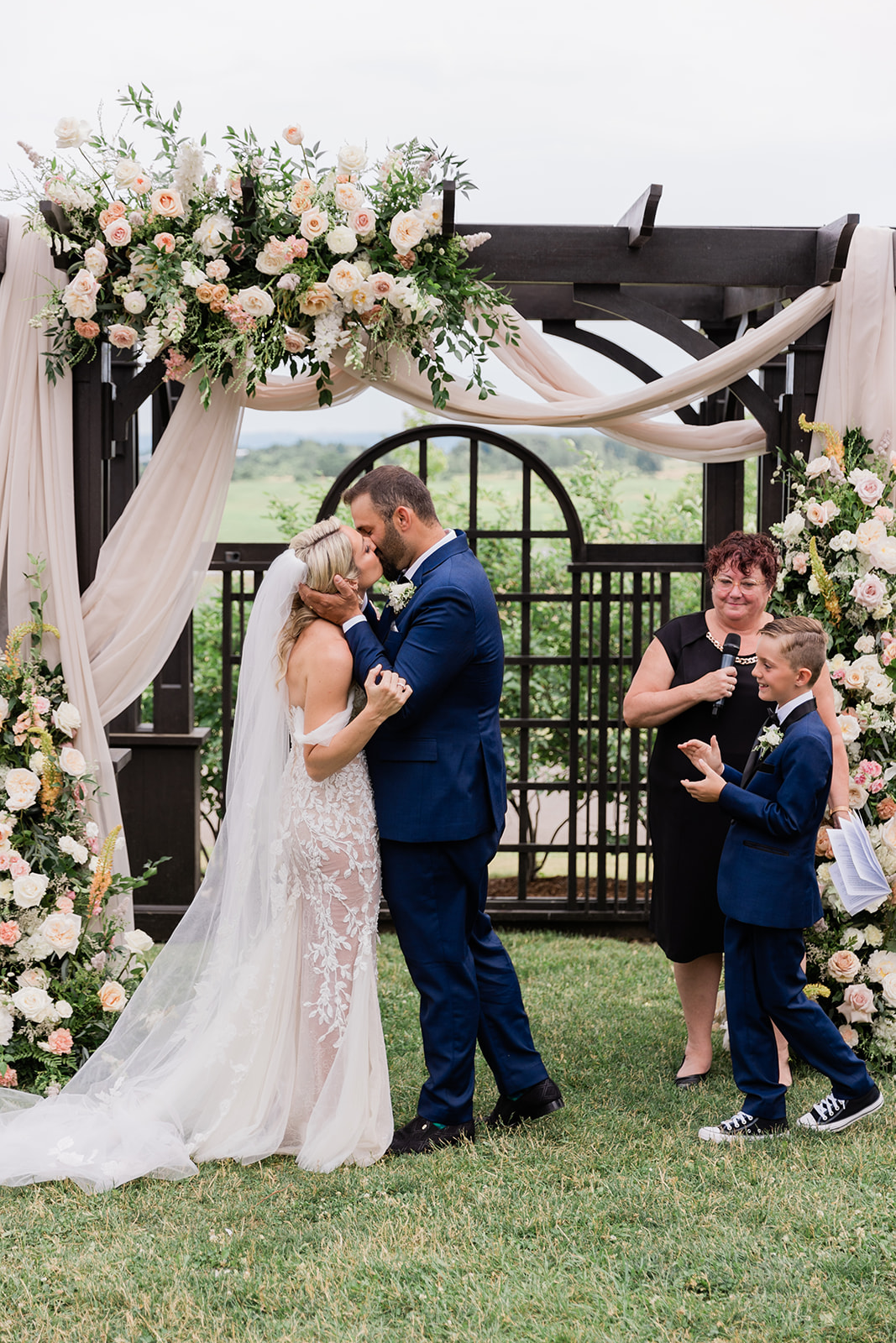 wedding ceremony first kiss at farm to table wedding by jess collins photography