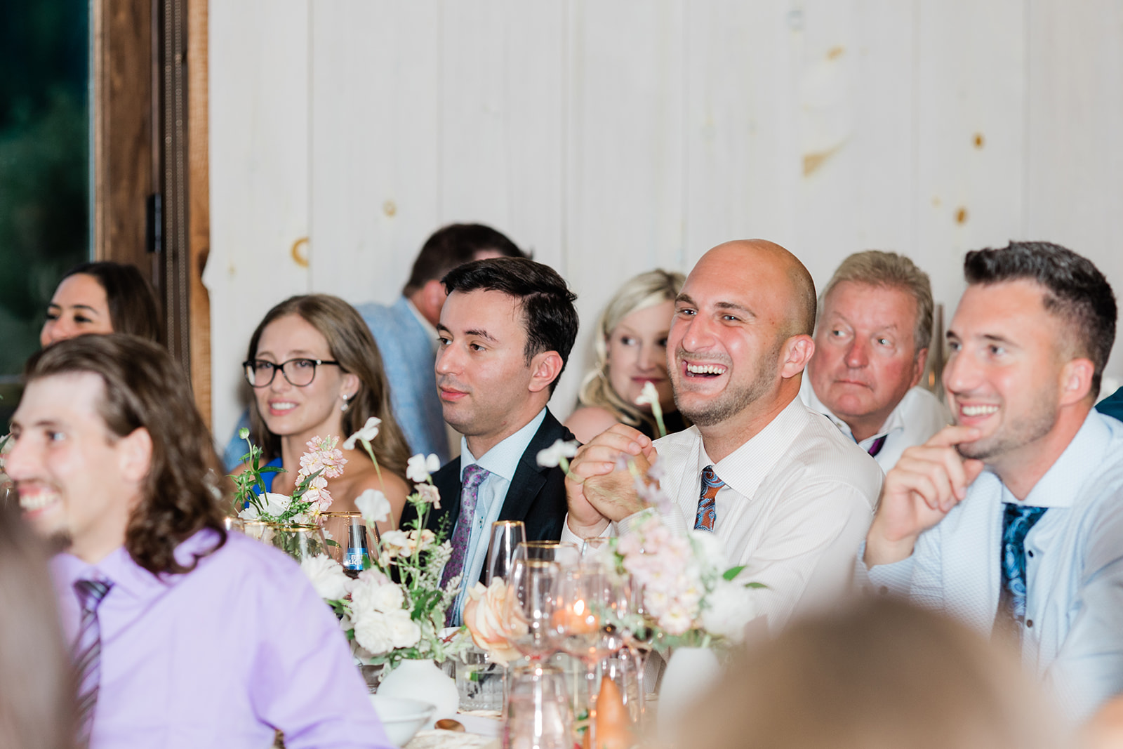 wedding reception guests laughing at farm to table wedding by jess collins photography