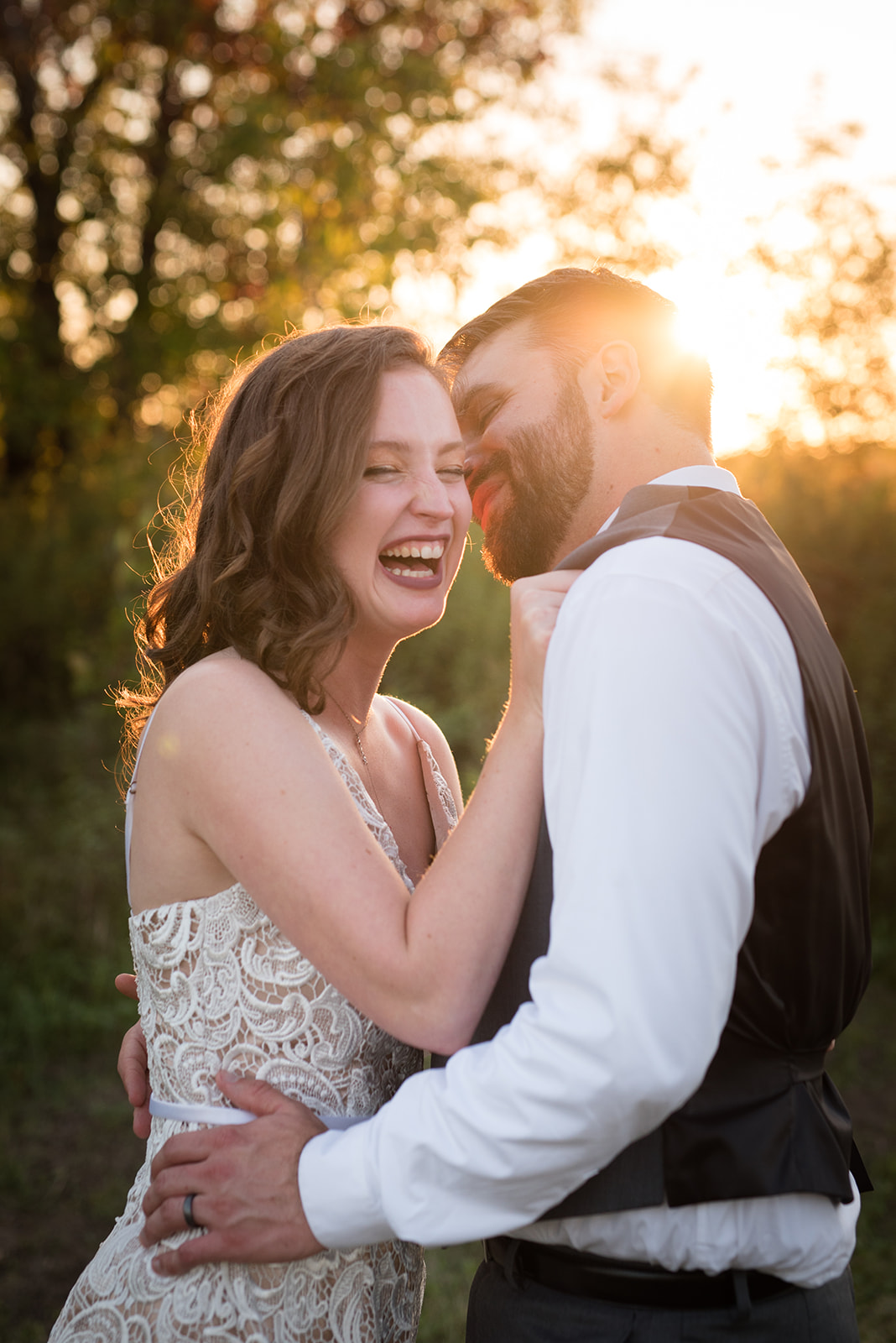 Groom kisses his bride during golden hour sunset photos at Erickson Farmstead captured by Minnesota wedding photographer
