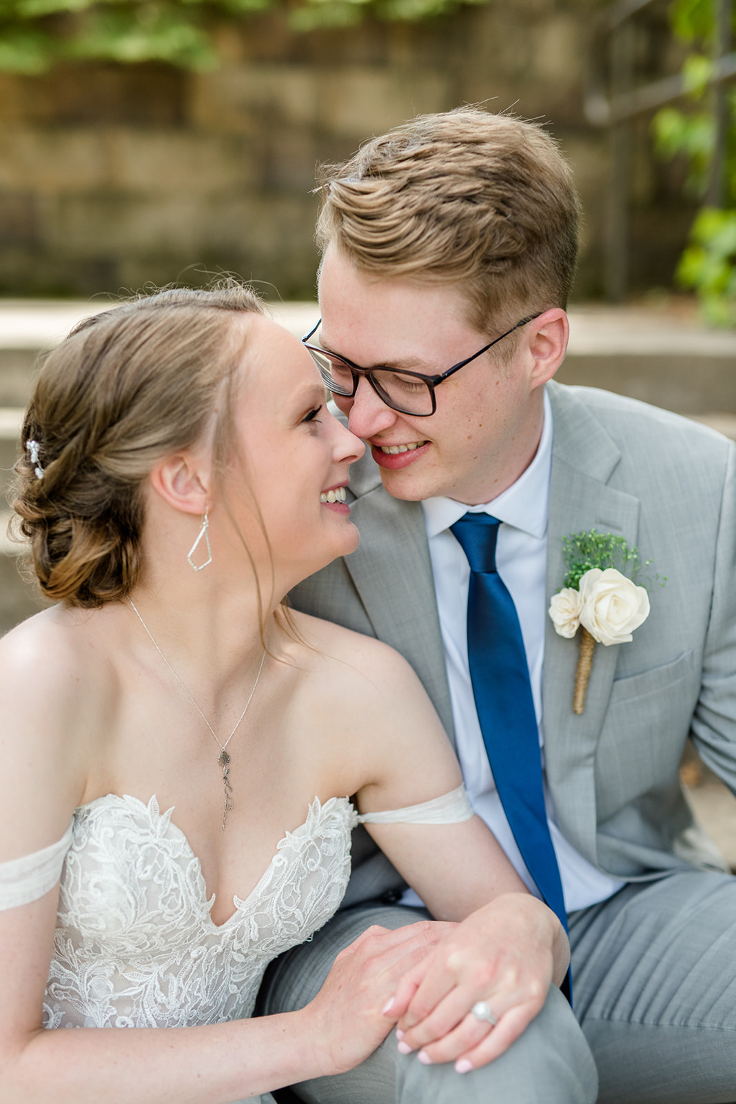 Bride and groom snuggle up on some steps at Bunker Hill in Minnesota
