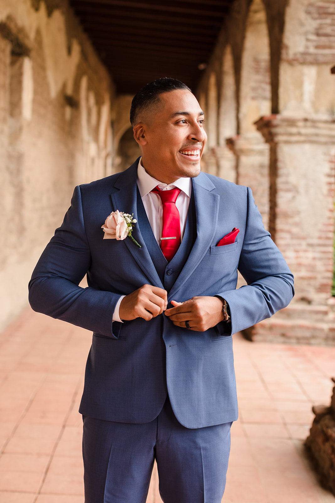 Groom's blue and red wedding attire