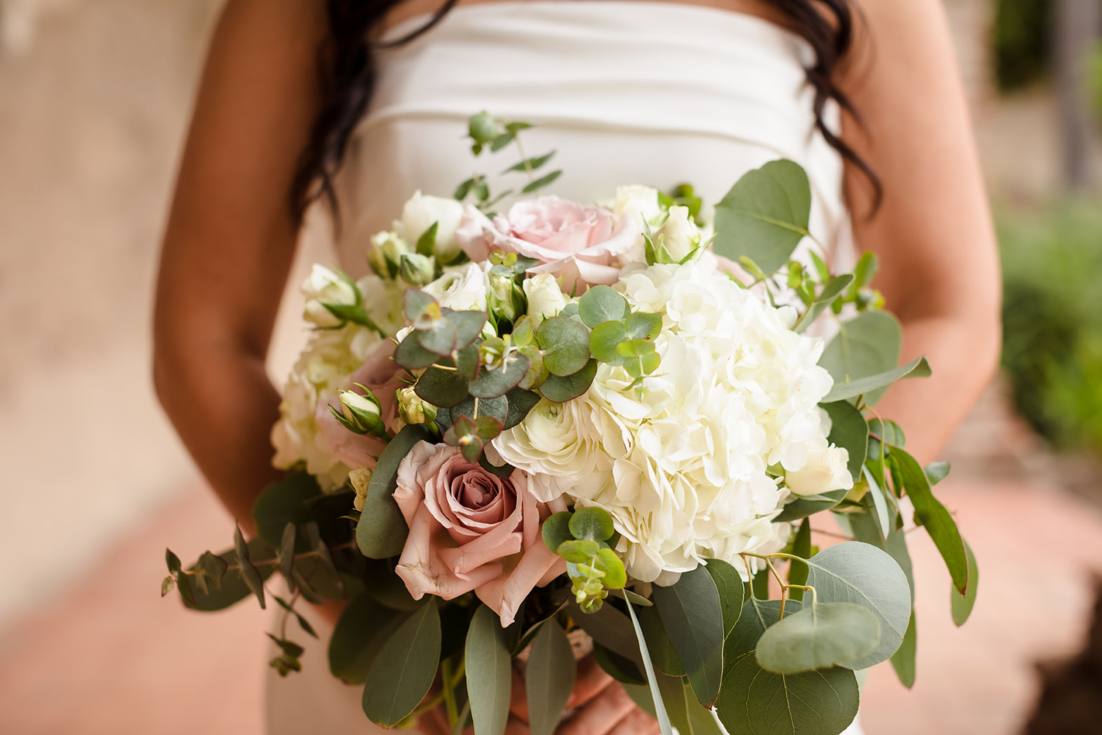 Bridal bouquet of dusty pink roses, white hydrangeas, and eucalyptus leaves