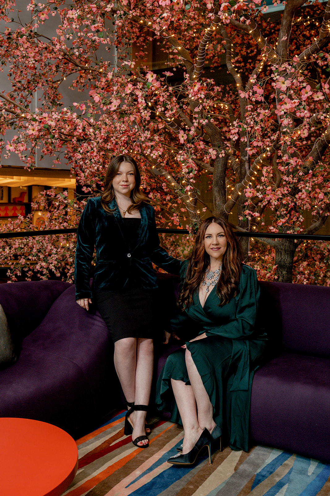 Real Housewives take on Mother and Daughter posing in front of indoor tree at Lake Nona Wave Hotel