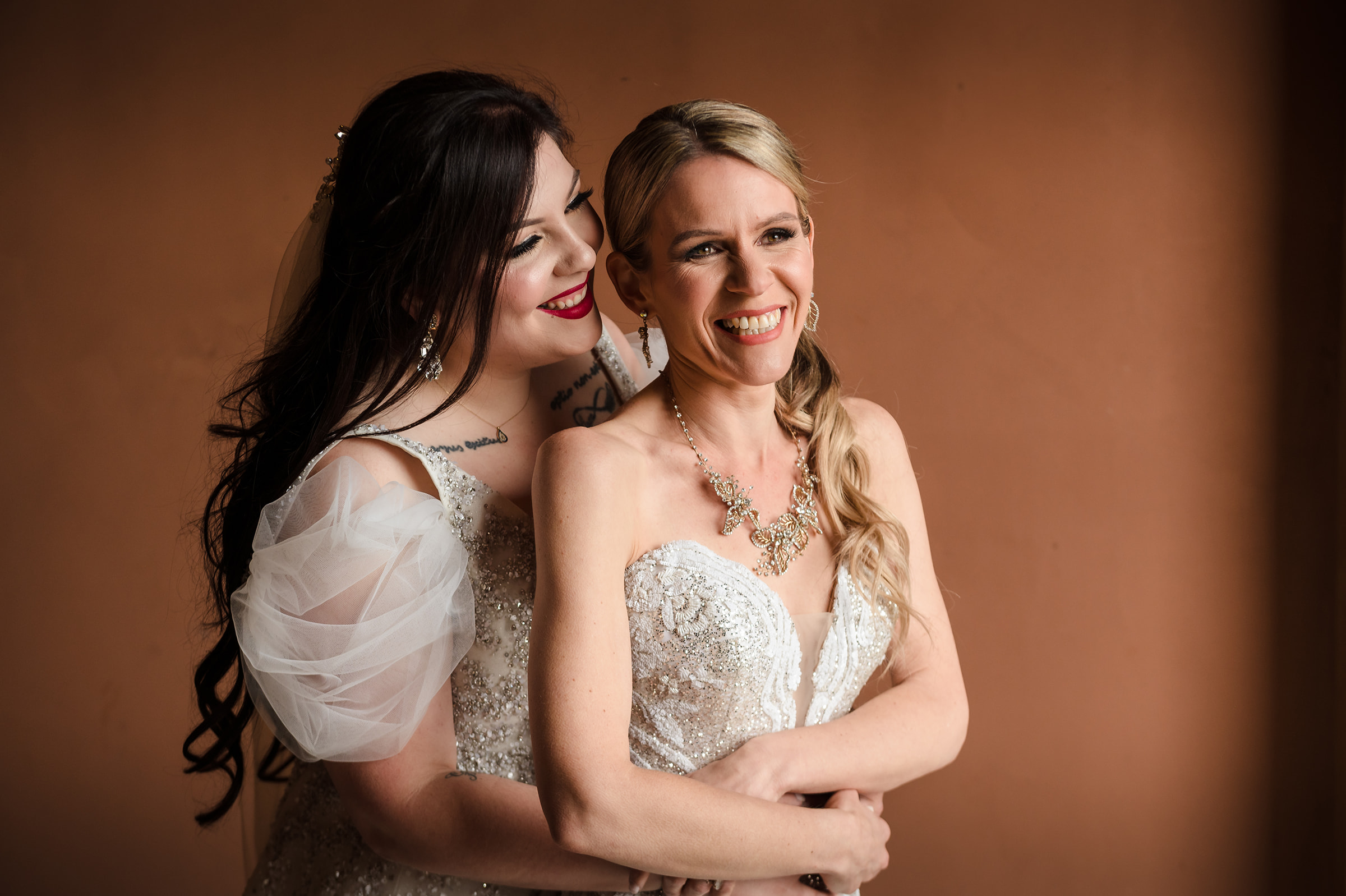Two brides cuddling at thier same sex wedding in Las Vegas