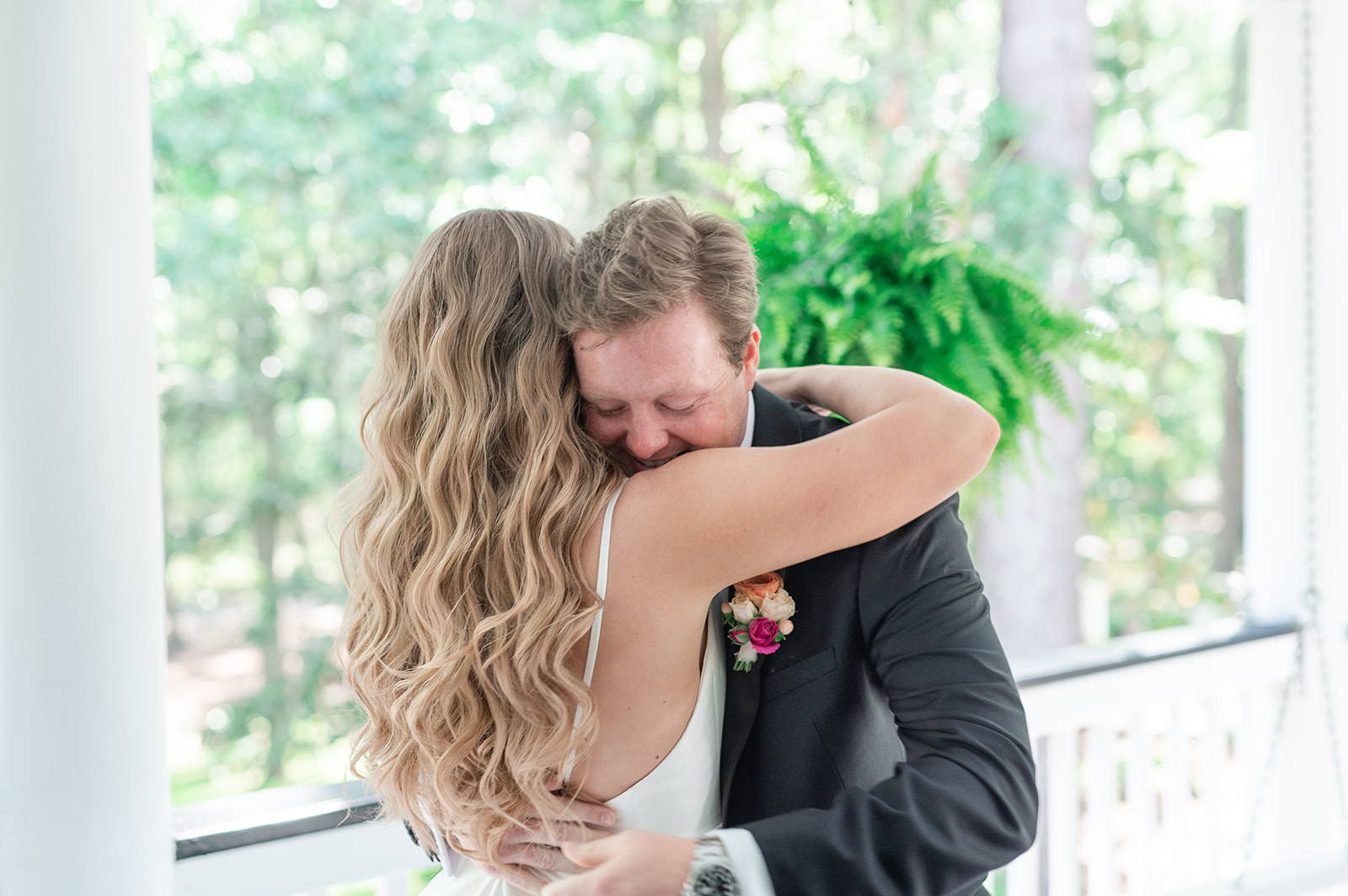 sweet moment with bride and groom on the porch of the Mackey House