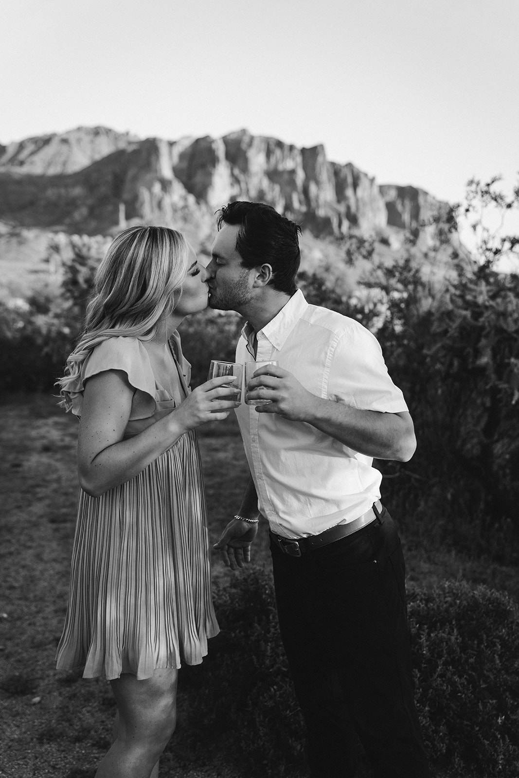 Popping champagne for engagement photos in the Phoenix Arizona Desert