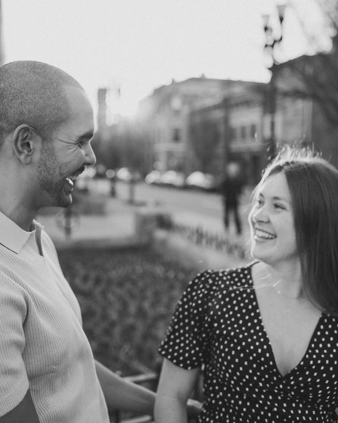 A candid moment caught in black and white of a couple laughing together