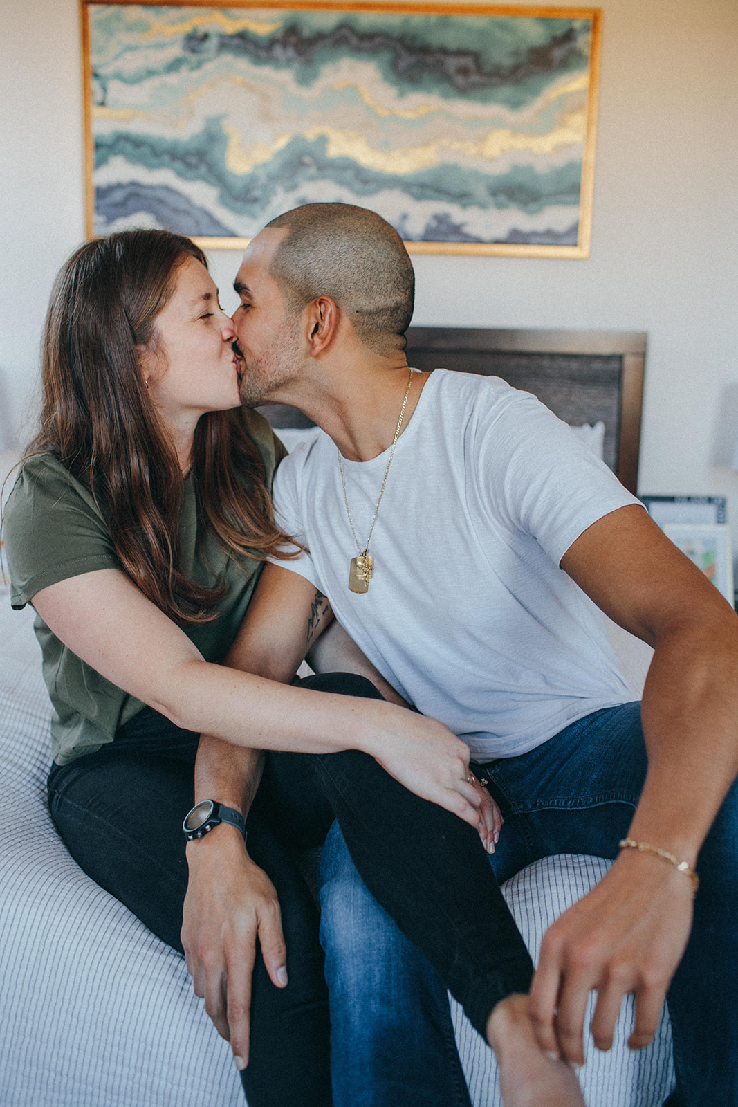 A couple sharing a sweet kiss in their downtown Cincinnati home