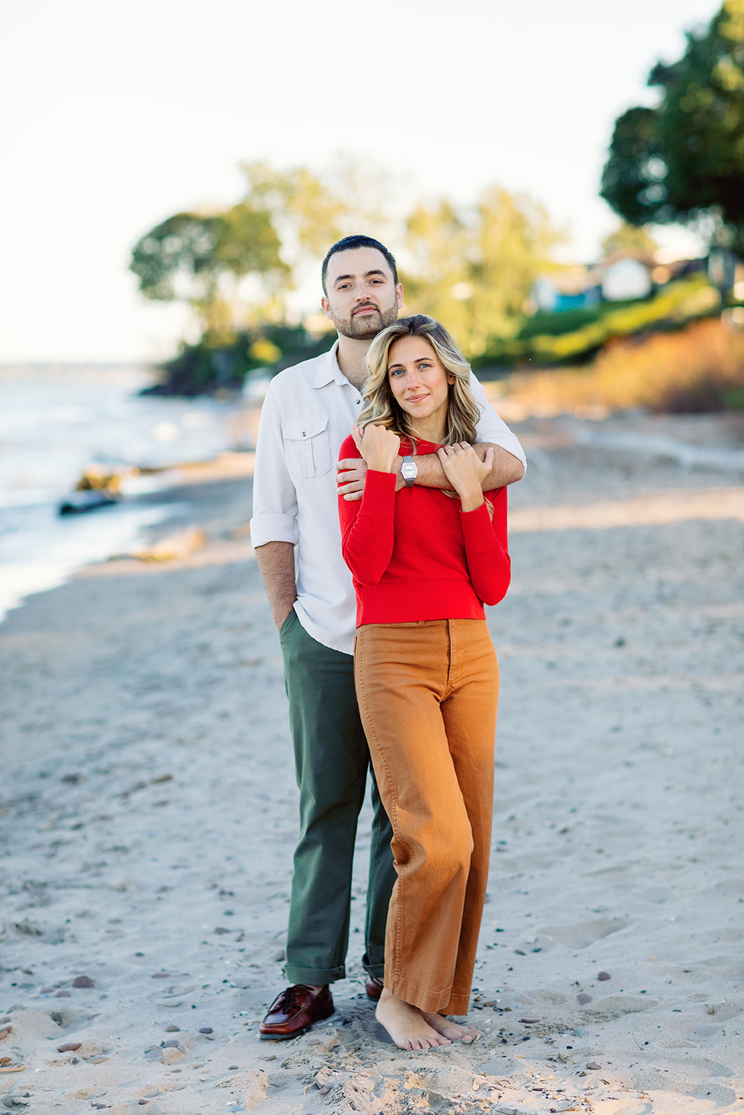A couple on the beach at Lake Ontario during their Rochester NY engagement session.