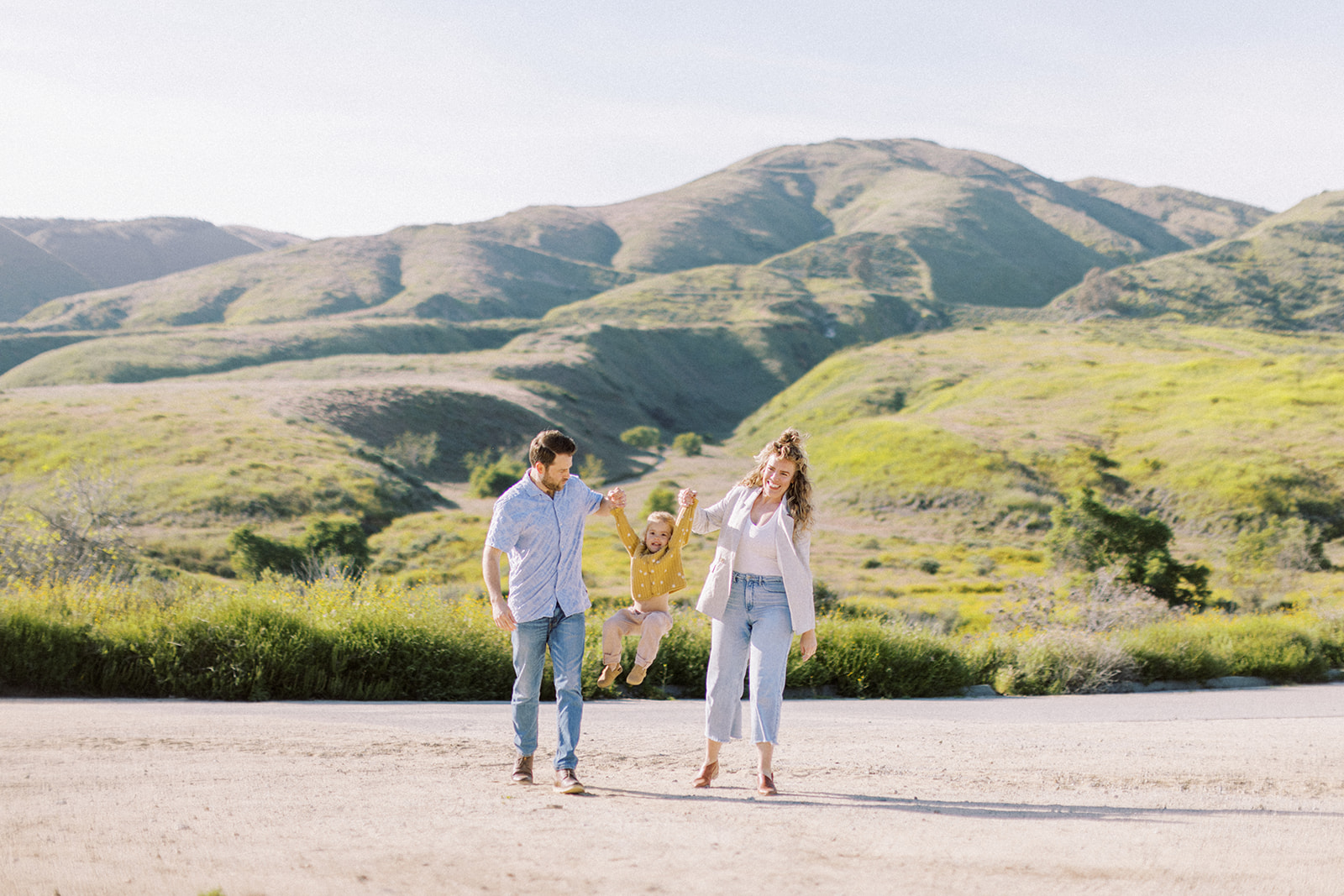 Southern California family session with green hills.