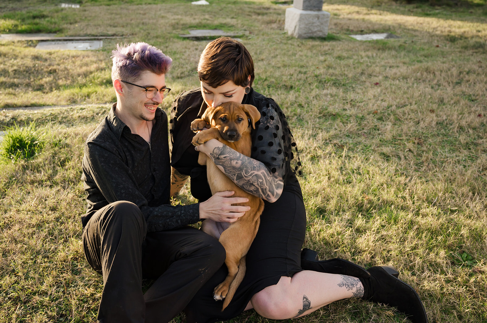 couple with puppy in cemetery engagement photos