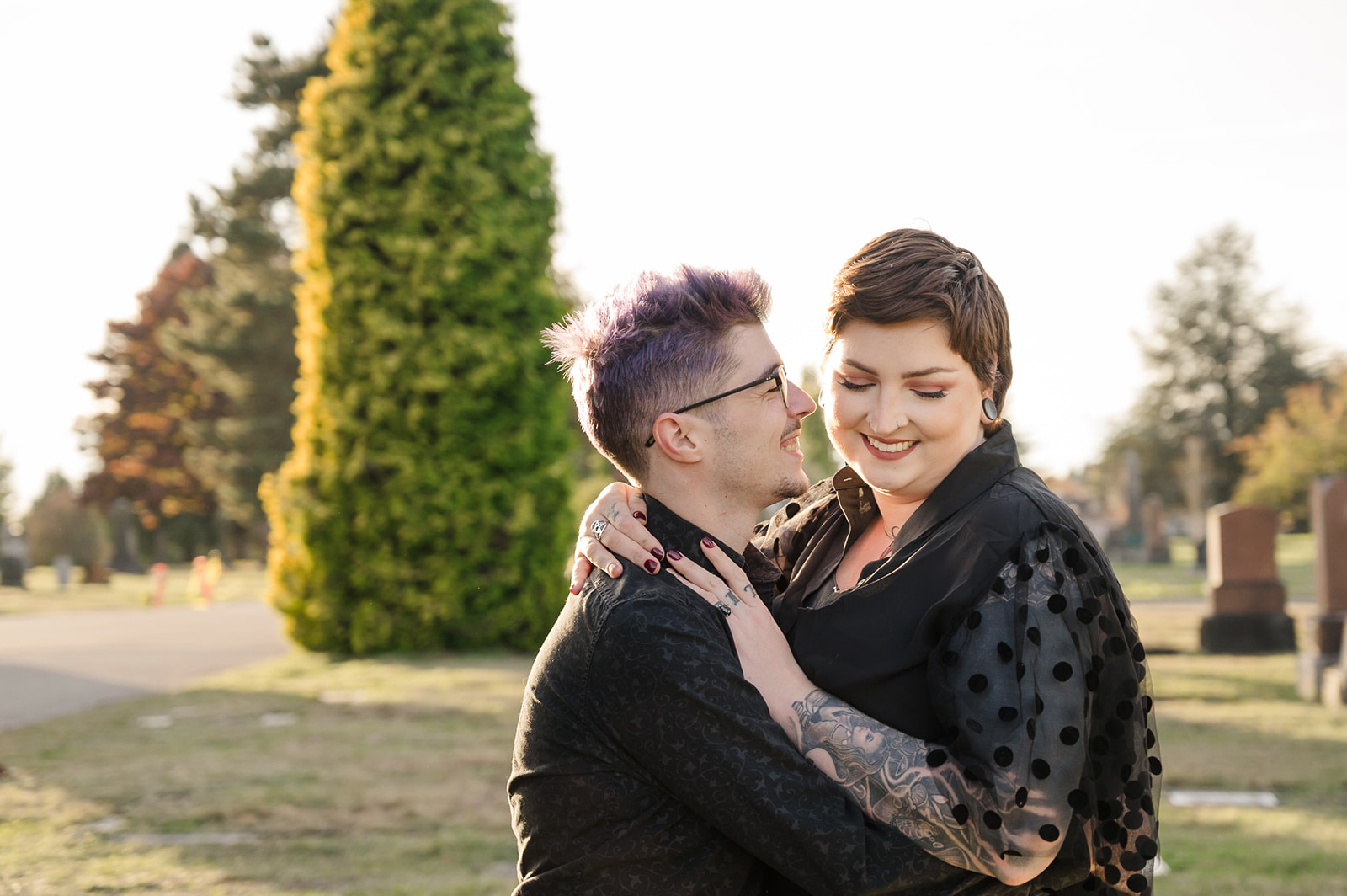 engagement photo of couple at sunset in a cemetery