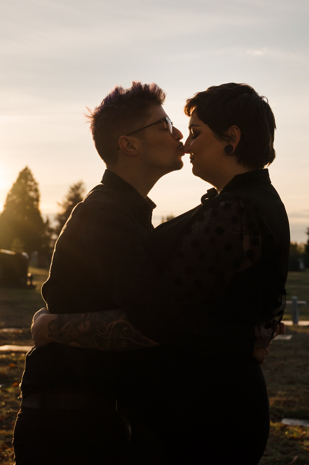 engagement photo of couple at sunset in a cemetery
