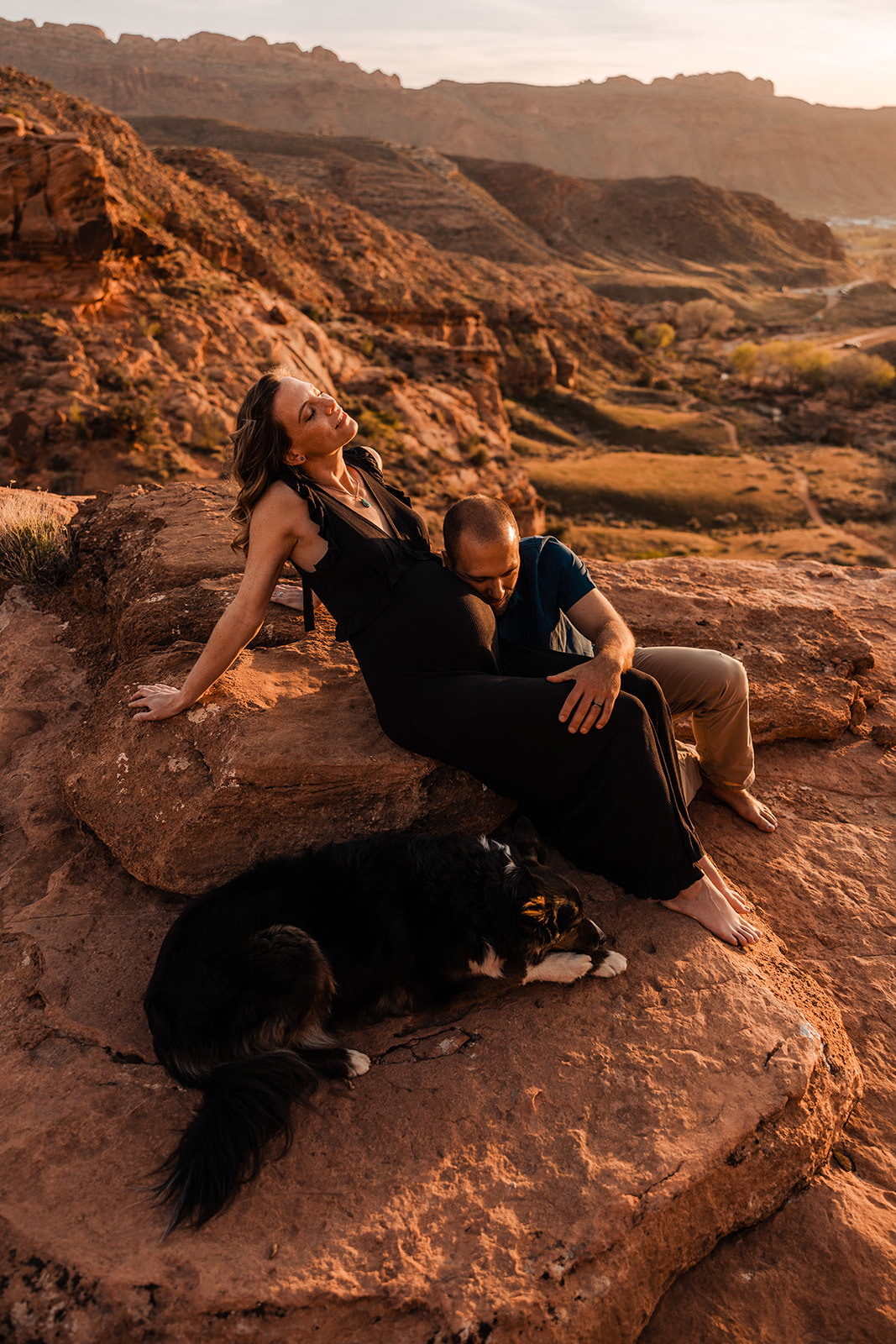 adventurous couple hikes for maternity portraits in the moab utah desert